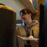 Person grabbing a pancake in Kirkhof Center lobby.